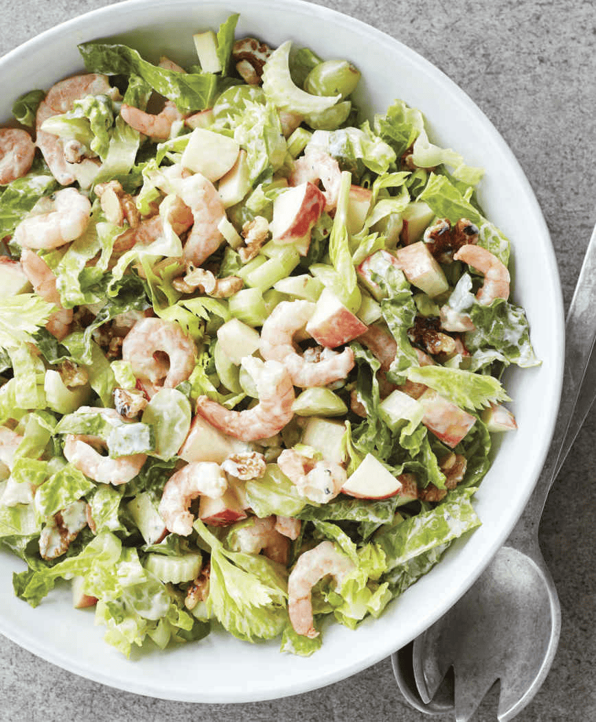 Healthy Shrimp Waldorf Salad with fresh shrimp, crisp apples, walnuts, and celery, topped with a light dressing and served on a bed of leafy greens.