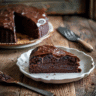 Moist chocolate banana cake sliced on a wooden table